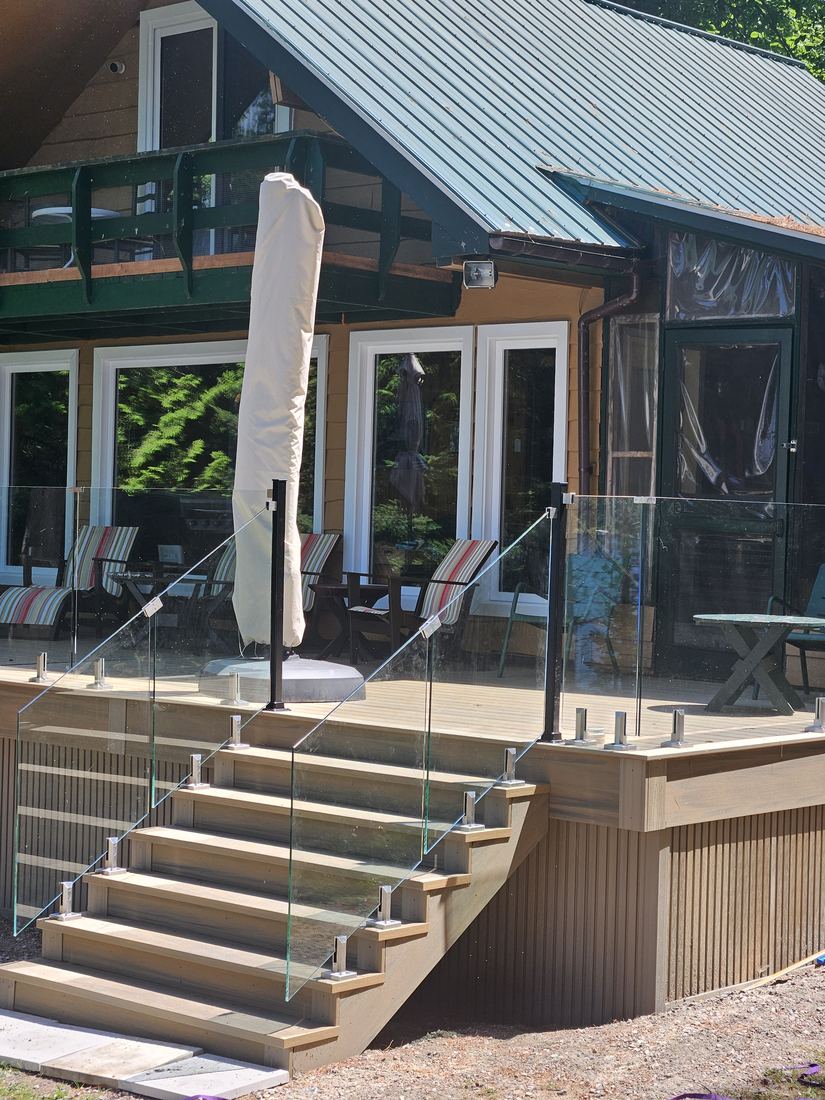 Composite stairs and glass railing at the chalet, close-up of the deck