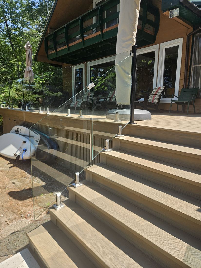 Front view of composite stairs and glass railing in front of the chalet’s French doors