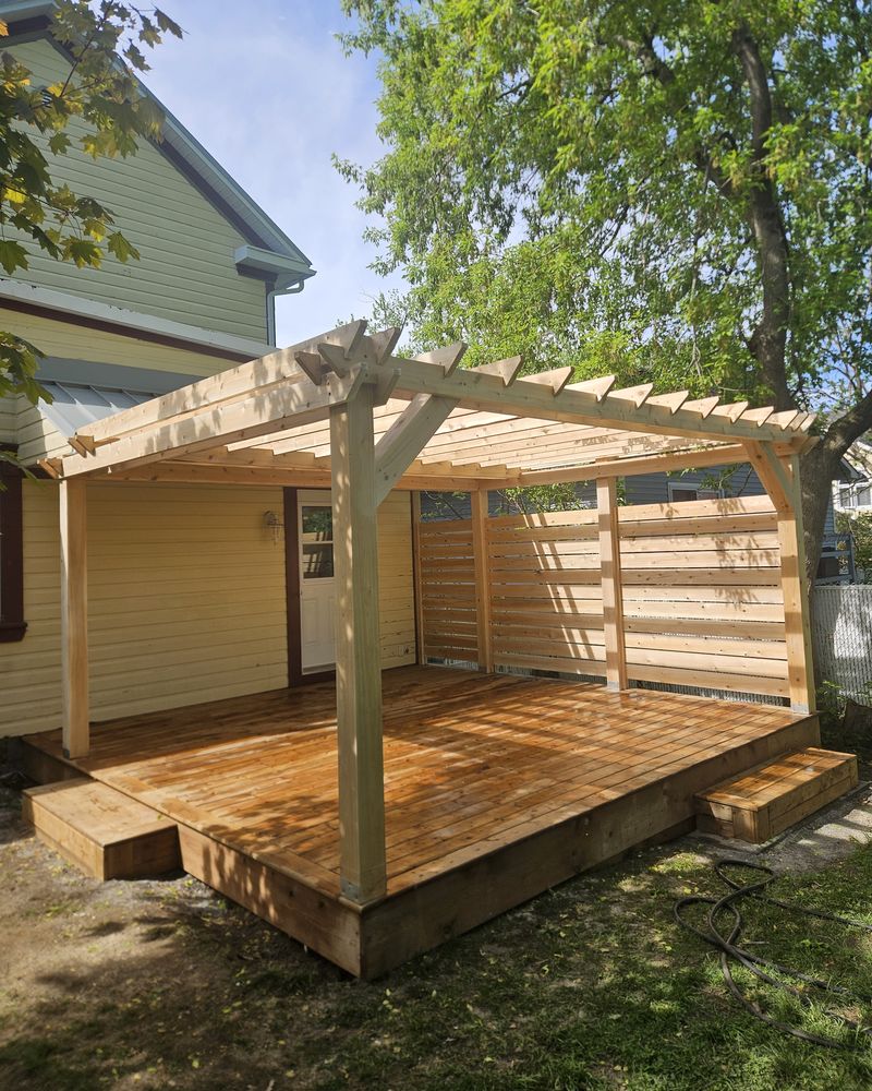 Wooden pergola with a slatted privacy screen over a wood deck