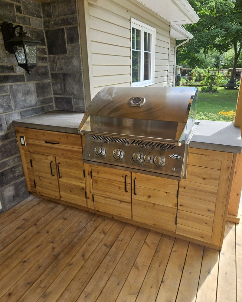 Wooden outdoor kitchen with a built-in barbecue on a covered deck